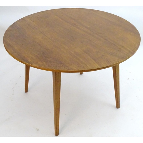 2217 - Vintage retro, Mid-century: A circular teak dining table raised on tapered legs. Labelled with 'Desi... 