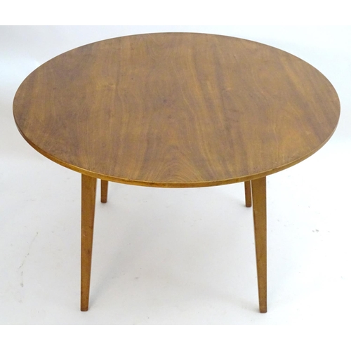 2217 - Vintage retro, Mid-century: A circular teak dining table raised on tapered legs. Labelled with 'Desi... 