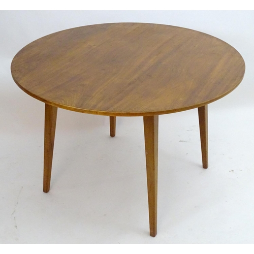 2217 - Vintage retro, Mid-century: A circular teak dining table raised on tapered legs. Labelled with 'Desi... 