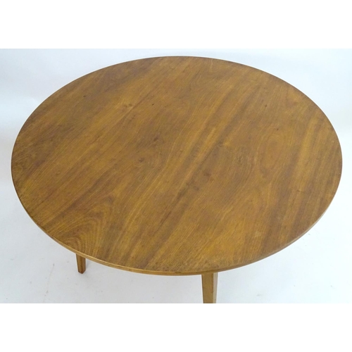 2217 - Vintage retro, Mid-century: A circular teak dining table raised on tapered legs. Labelled with 'Desi... 