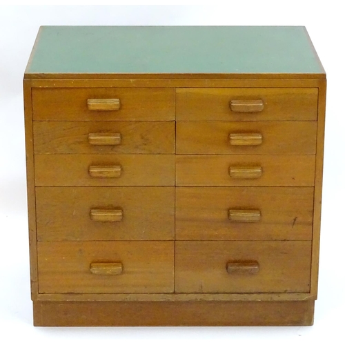 2219 - A mid 20thC cedar chest of drawers, comprising two flights of five drawers, with inset green vinyl t... 