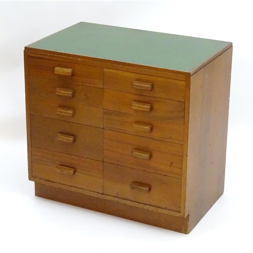 2219 - A mid 20thC cedar chest of drawers, comprising two flights of five drawers, with inset green vinyl t... 