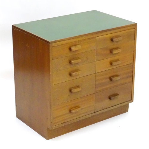 2219 - A mid 20thC cedar chest of drawers, comprising two flights of five drawers, with inset green vinyl t... 