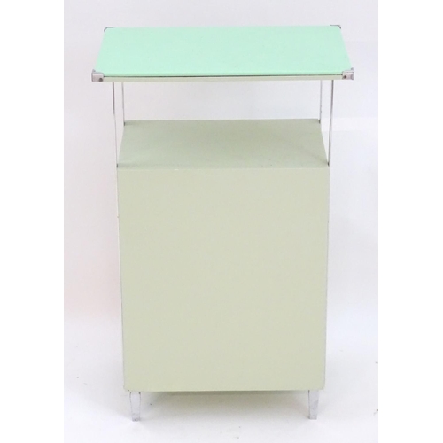 2220 - An Art Deco bathroom / bedside cabinet, the mint green glass top supported by chromed mounts above a... 