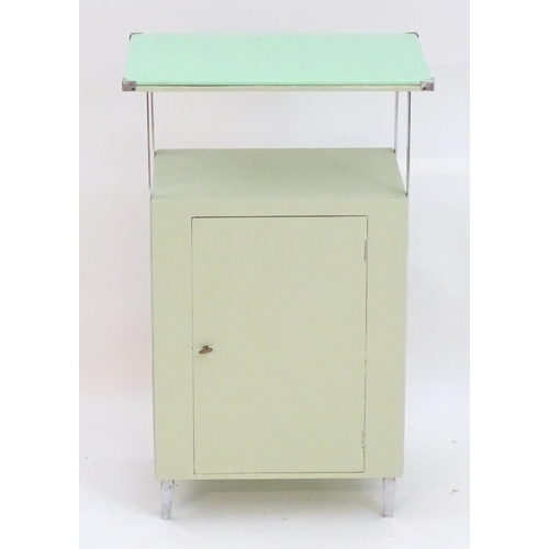 2220 - An Art Deco bathroom / bedside cabinet, the mint green glass top supported by chromed mounts above a... 