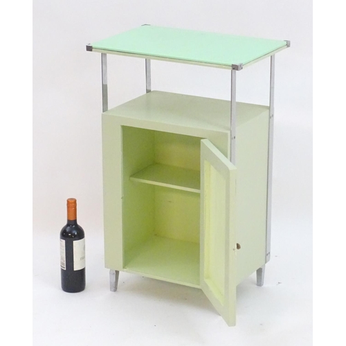 2220 - An Art Deco bathroom / bedside cabinet, the mint green glass top supported by chromed mounts above a... 