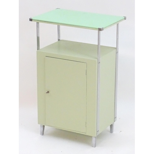 2220 - An Art Deco bathroom / bedside cabinet, the mint green glass top supported by chromed mounts above a... 