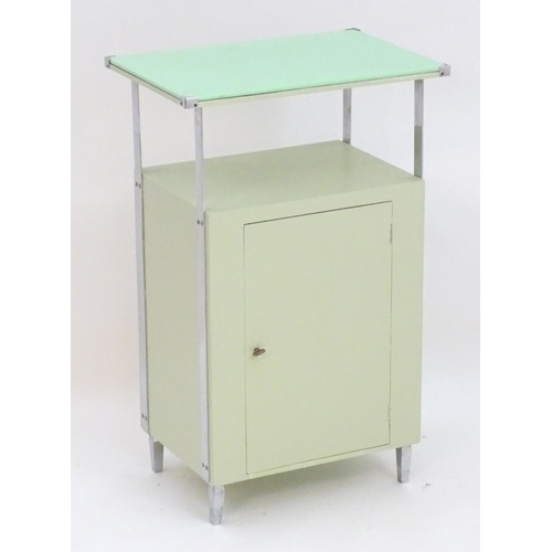 2220 - An Art Deco bathroom / bedside cabinet, the mint green glass top supported by chromed mounts above a... 