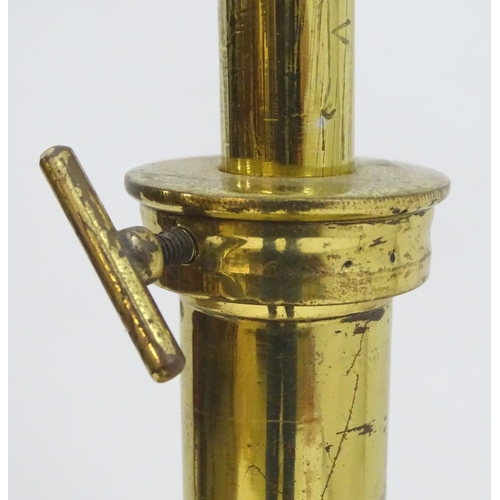 2246 - A 19thC Arts and Crafts brass standard lamp, converted to electricity, the height adjustable shaft s... 