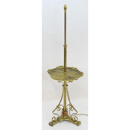 2246 - A 19thC Arts and Crafts brass standard lamp, converted to electricity, the height adjustable shaft s... 