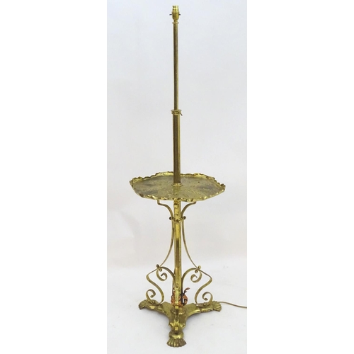 2246 - A 19thC Arts and Crafts brass standard lamp, converted to electricity, the height adjustable shaft s... 