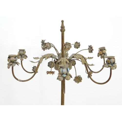 2250 - An early to mid 20thC patinated metal floor standing candelabra, the six cups formed as flower heads... 