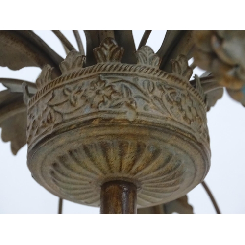 2250 - An early to mid 20thC patinated metal floor standing candelabra, the six cups formed as flower heads... 