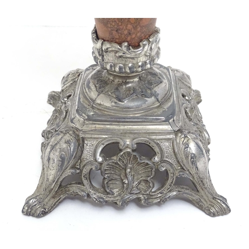 2254 - A late 19thC oil lamp, the silver plated base supporting a granite column below a peach glass reserv... 