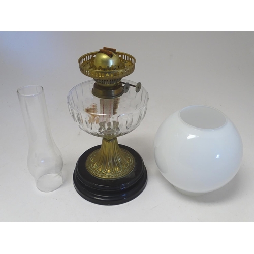 2259 - An early 20thC oil table lamp, the white globular glass shade supported by a clear cut glass reservo... 