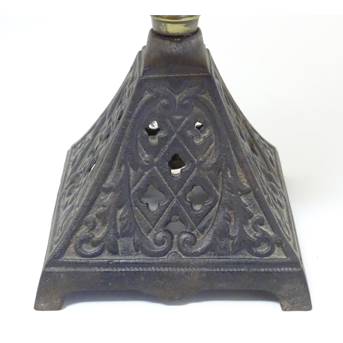 2265 - A late 19thC Duplex oil lamp, with bronzed glass shade and reservoir, standing on a cast iron base w... 