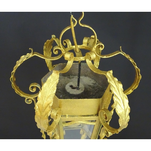 2271 - A gilt metal pendant lantern of hexagonal form with scrolled detail, approx. 27