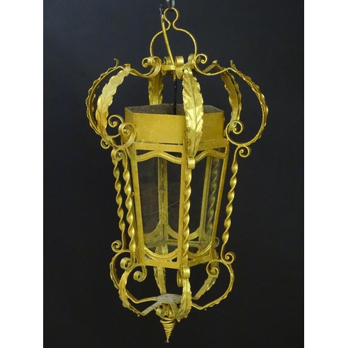 2271 - A gilt metal pendant lantern of hexagonal form with scrolled detail, approx. 27