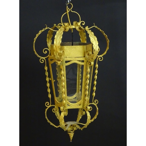 2271 - A gilt metal pendant lantern of hexagonal form with scrolled detail, approx. 27