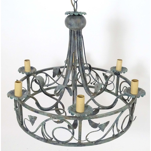 2274 - A 20thC pendant ceiling light, the circular frame supporting six lamps, with ivy and lily leaf decor... 