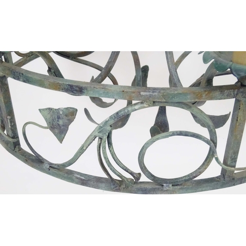 2274 - A 20thC pendant ceiling light, the circular frame supporting six lamps, with ivy and lily leaf decor... 