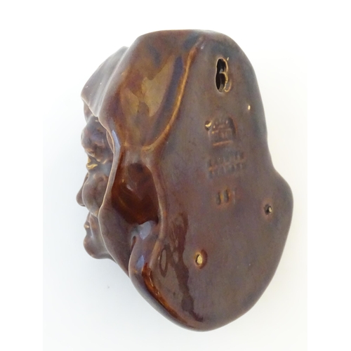 108 - A Bretby treacle glaze wall pocket modelled as a male head. Marked under, pattern number 887. Approx... 