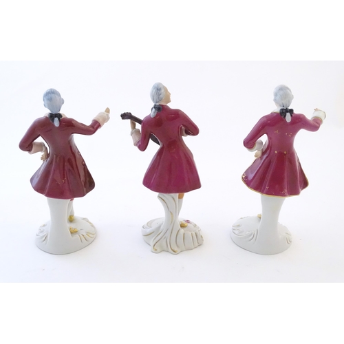 110 - Three Royal Dux figures modelled as an 18th century gentleman, one with a string instrument. Marked ... 