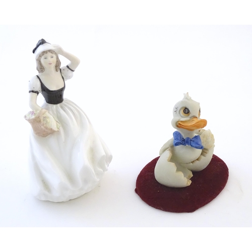 112 - A Coalport model of a lady, Susan. Together with a Capodimonte model of a duck with a blue bow tie. ... 