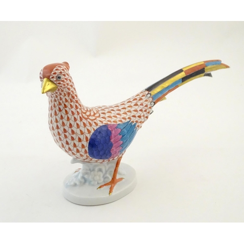 120 - A Herend pottery model of a pheasant with fishnet decoration and gilt highlights. Marked under. Appr... 