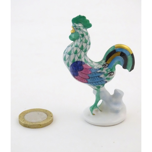 121 - A Herend pottery model of a cockerel with fishnet decoration and gilt highlights. Marked under. Appr... 