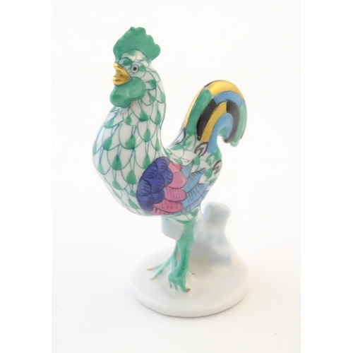 121 - A Herend pottery model of a cockerel with fishnet decoration and gilt highlights. Marked under. Appr... 