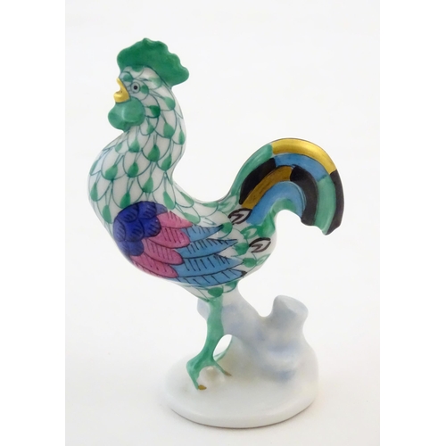 121 - A Herend pottery model of a cockerel with fishnet decoration and gilt highlights. Marked under. Appr... 