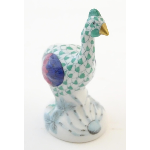 122 - A Herend pottery model of a guinea fowl with fishnet decoration and gilt highlights. Marked under. A... 