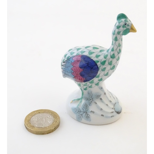 122 - A Herend pottery model of a guinea fowl with fishnet decoration and gilt highlights. Marked under. A... 