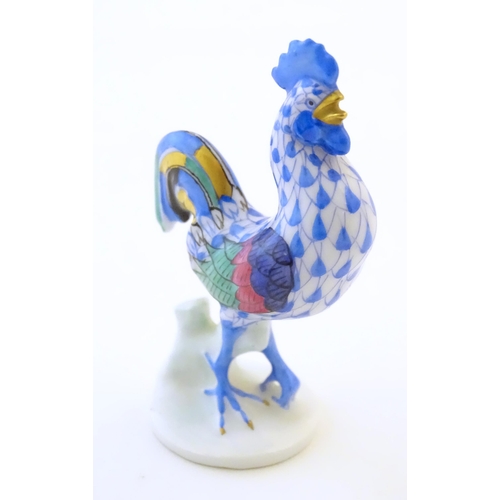 123 - A Herend pottery model of a cockerel with fishnet decoration and gilt highlights. Marked under. Appr... 