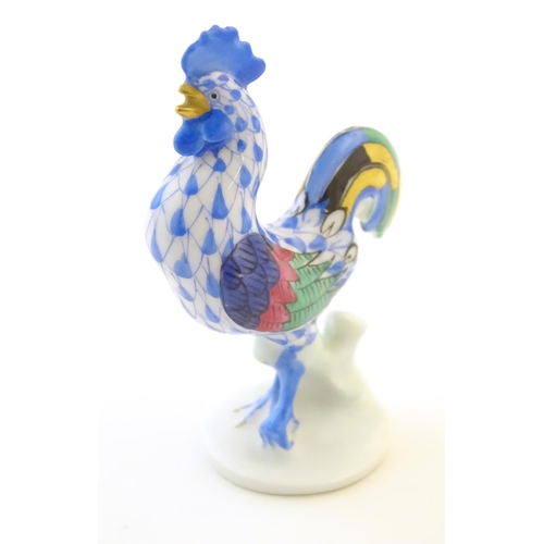 123 - A Herend pottery model of a cockerel with fishnet decoration and gilt highlights. Marked under. Appr... 