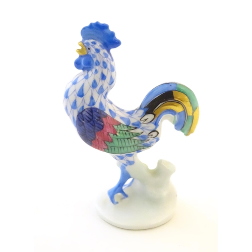 123 - A Herend pottery model of a cockerel with fishnet decoration and gilt highlights. Marked under. Appr... 