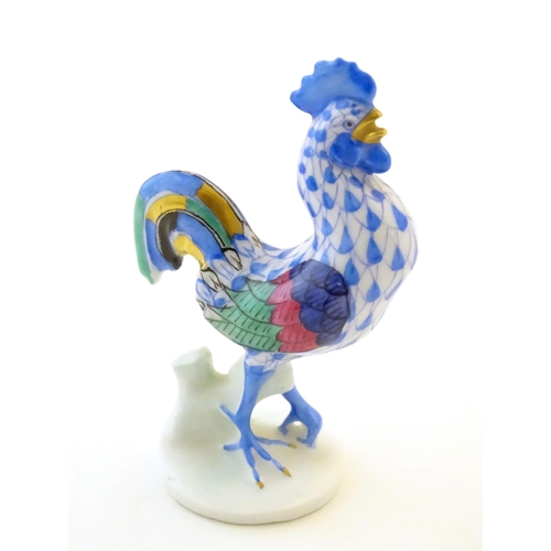 123 - A Herend pottery model of a cockerel with fishnet decoration and gilt highlights. Marked under. Appr... 