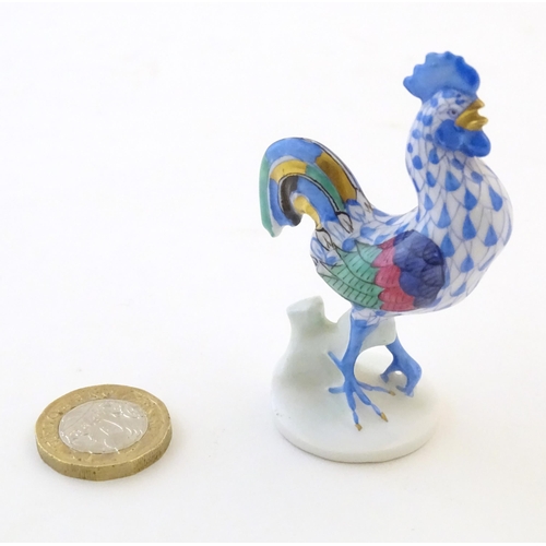 123 - A Herend pottery model of a cockerel with fishnet decoration and gilt highlights. Marked under. Appr... 