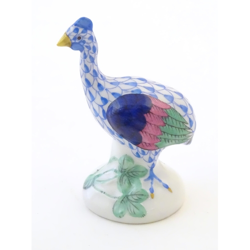 124 - A Herend pottery model of a guinea fowl with fishnet decoration and gilt highlights. Marked under. A... 