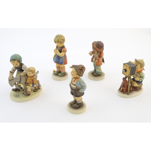 135 - Five Hummel / Goebel figures comprising The Photographer, no. 179, Homeward Bound, no. 334, Little F... 