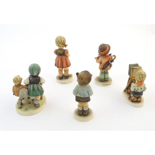 135 - Five Hummel / Goebel figures comprising The Photographer, no. 179, Homeward Bound, no. 334, Little F... 