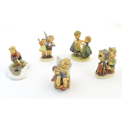 139 - Five Hummel / Goebel figures comprising The Photographer, no. 178, Let's Take to the Ice, no. 2143, ... 