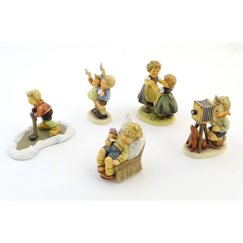 139 - Five Hummel / Goebel figures comprising The Photographer, no. 178, Let's Take to the Ice, no. 2143, ... 