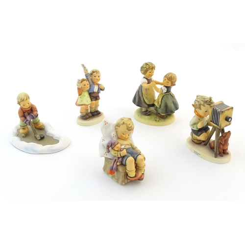 139 - Five Hummel / Goebel figures comprising The Photographer, no. 178, Let's Take to the Ice, no. 2143, ... 