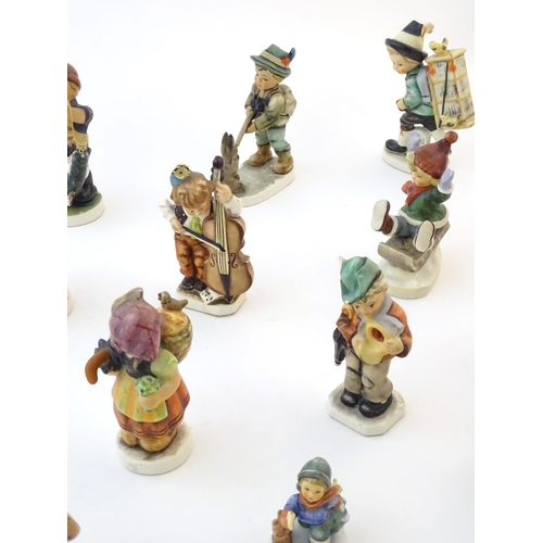 145 - A quantity of Friedel figures to include a boy playing the cello, an artist with easel and palette, ... 