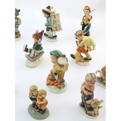 145 - A quantity of Friedel figures to include a boy playing the cello, an artist with easel and palette, ... 