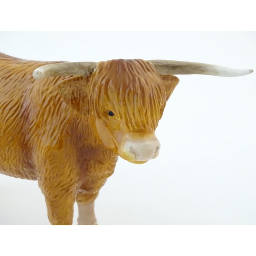 146 - A John Beswick model of a Highland cow, together with a John Beswick Highland calf. Marked under. La... 