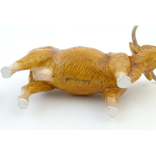 146 - A John Beswick model of a Highland cow, together with a John Beswick Highland calf. Marked under. La... 