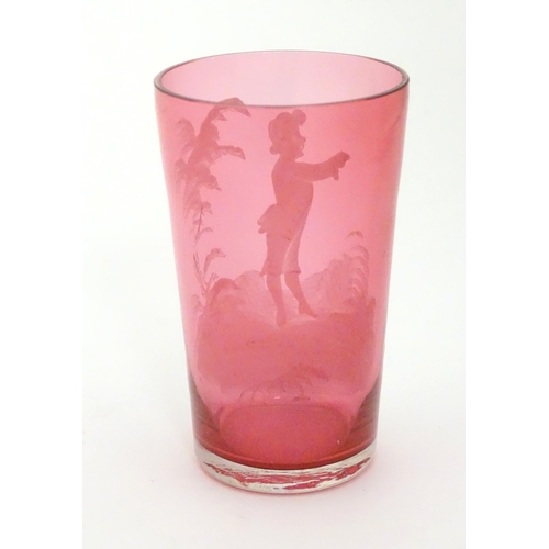 280 - A Cranberry glass beaker with Mary Gregory style white enamel decoration. 4 1/4